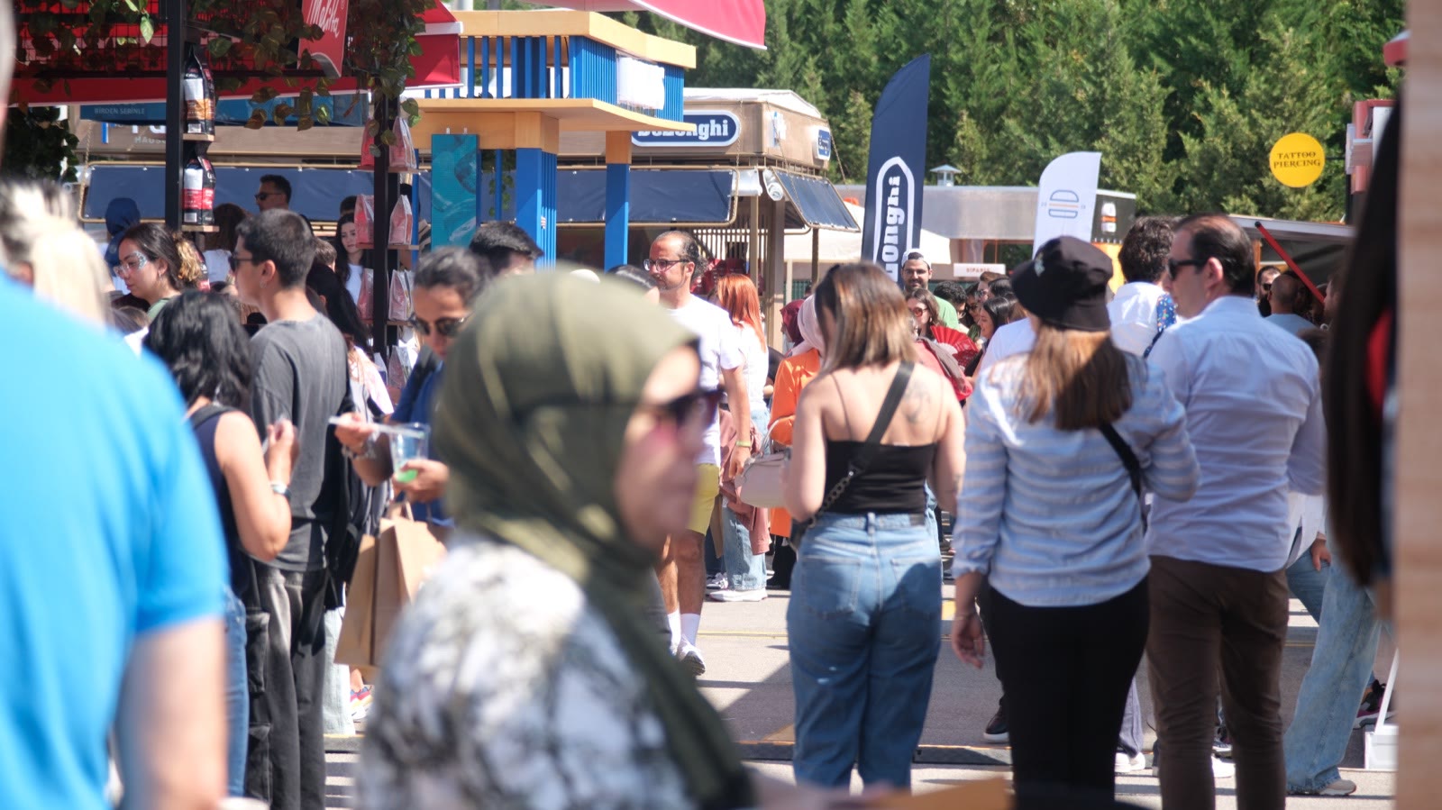 Visitors walking between the stands in the sun