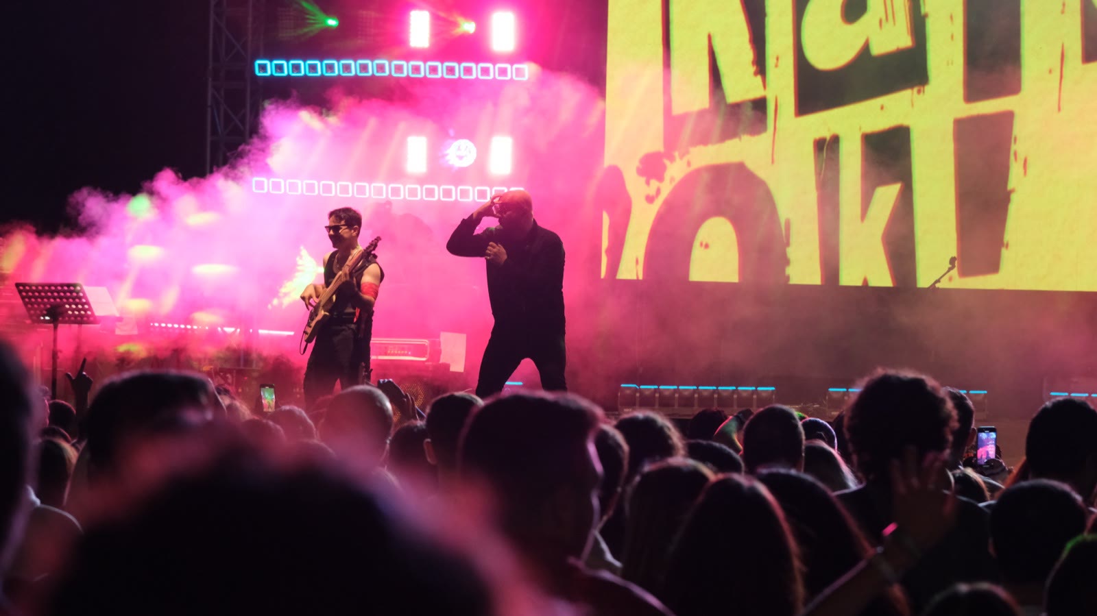 A rock band in pink stage light