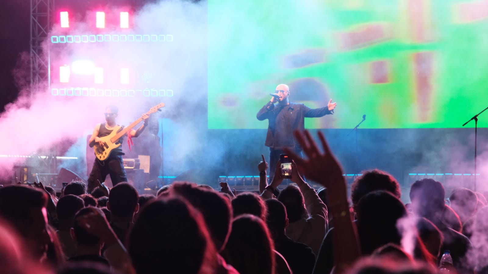 A singer in front of a green LED wall