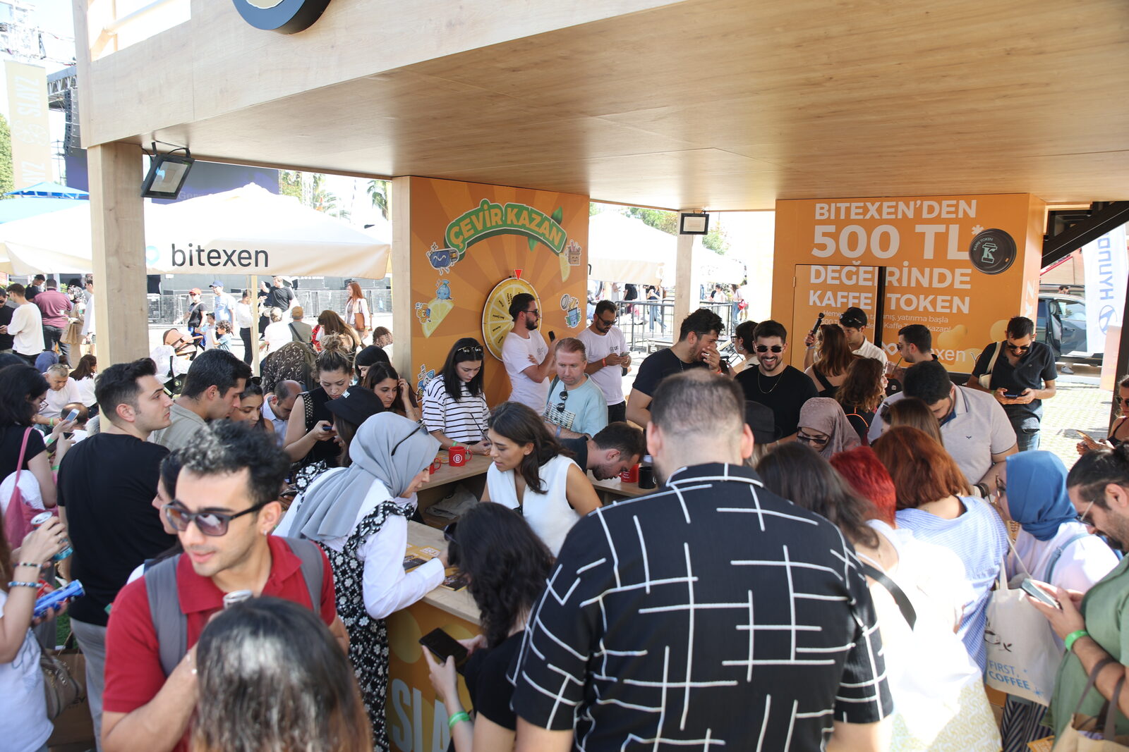 A crowded aisle between stands inside the hall