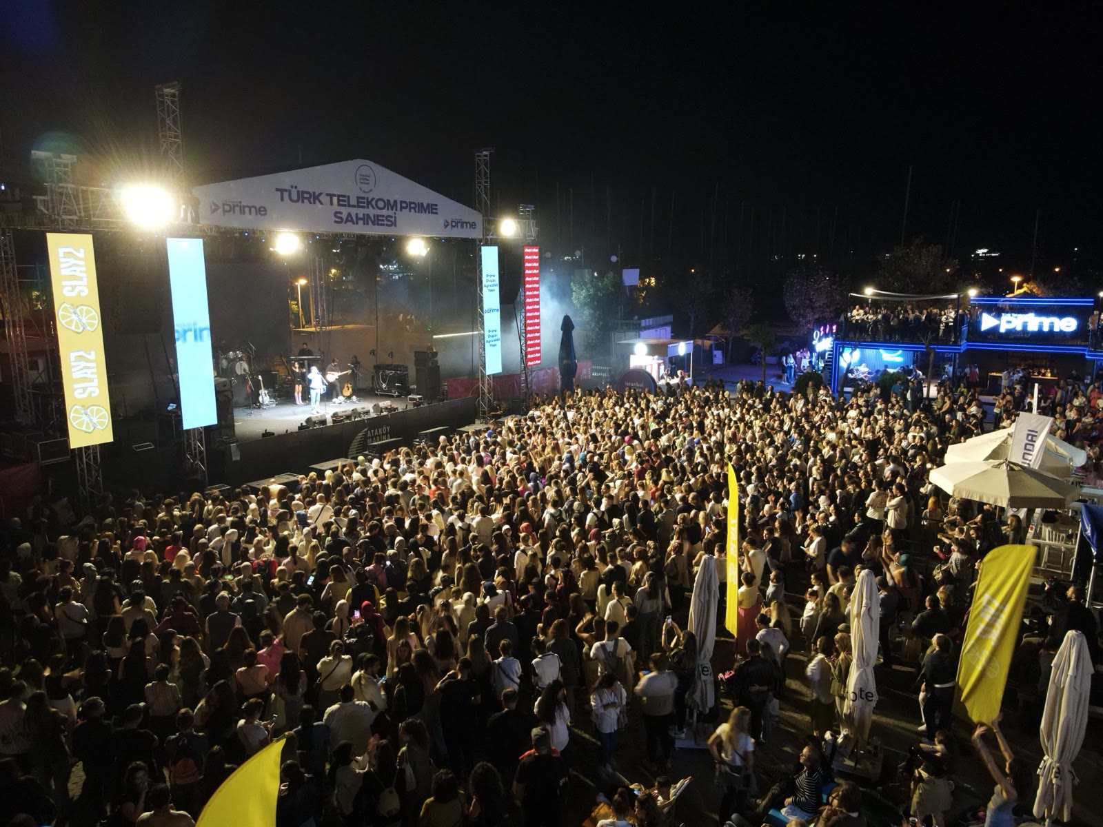 The main stage at night, seen over thousands of visitors